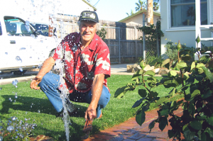 A Brentwood Sprinkler Repair team member releases the pressure on a pop up system