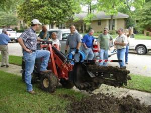 the Brentwood Sprinkler repair team trenches a new line